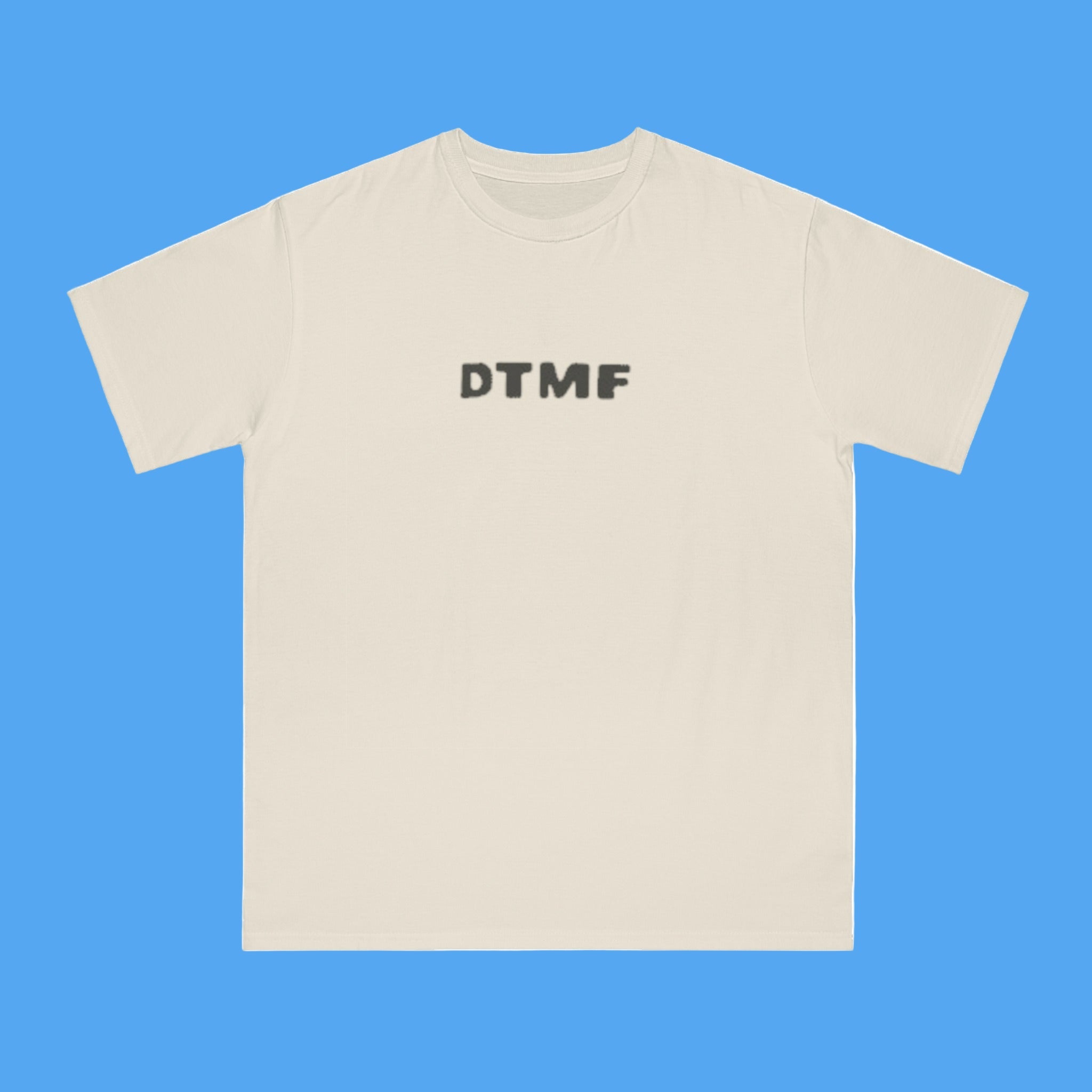 Beige t-shirt with 'DTMF' text on a white background